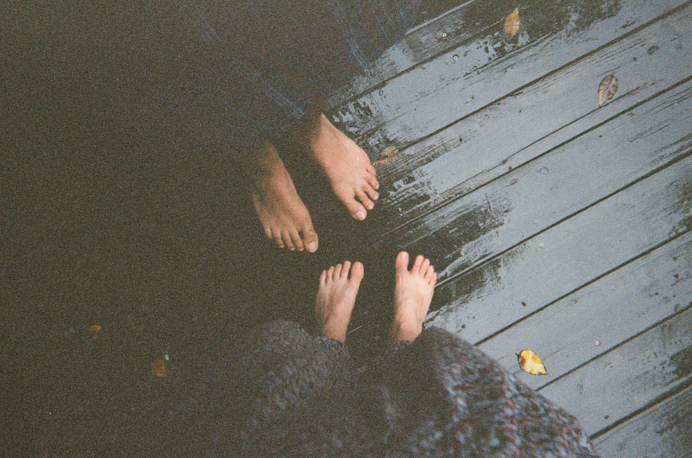 a couple of people standing on top of a wooden floor