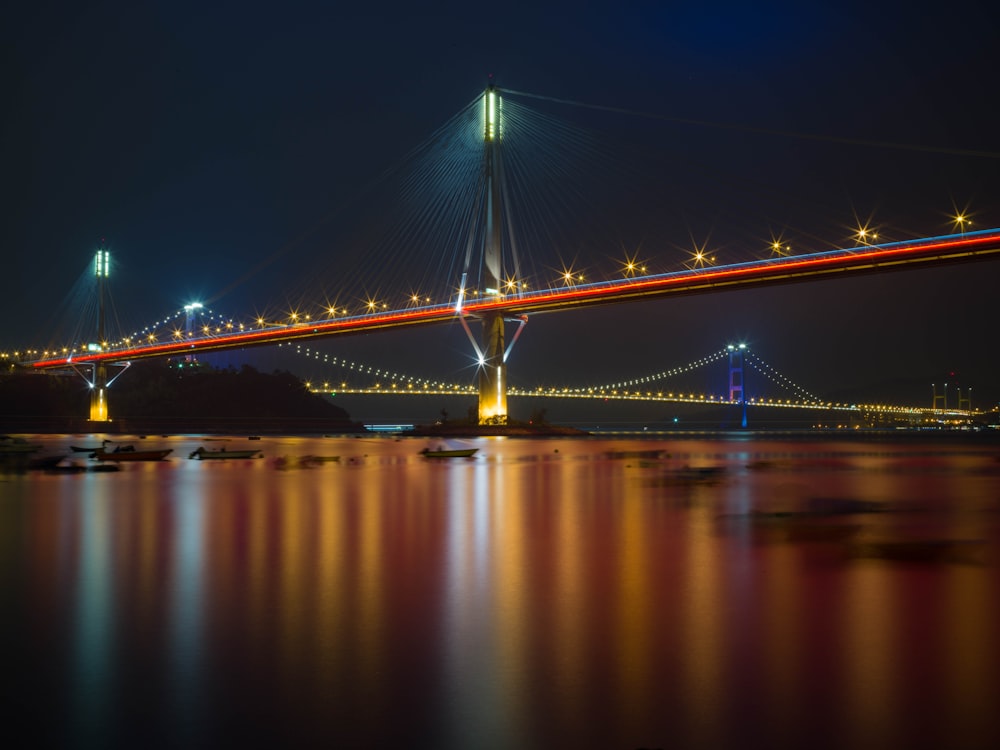 a long bridge over a body of water at night