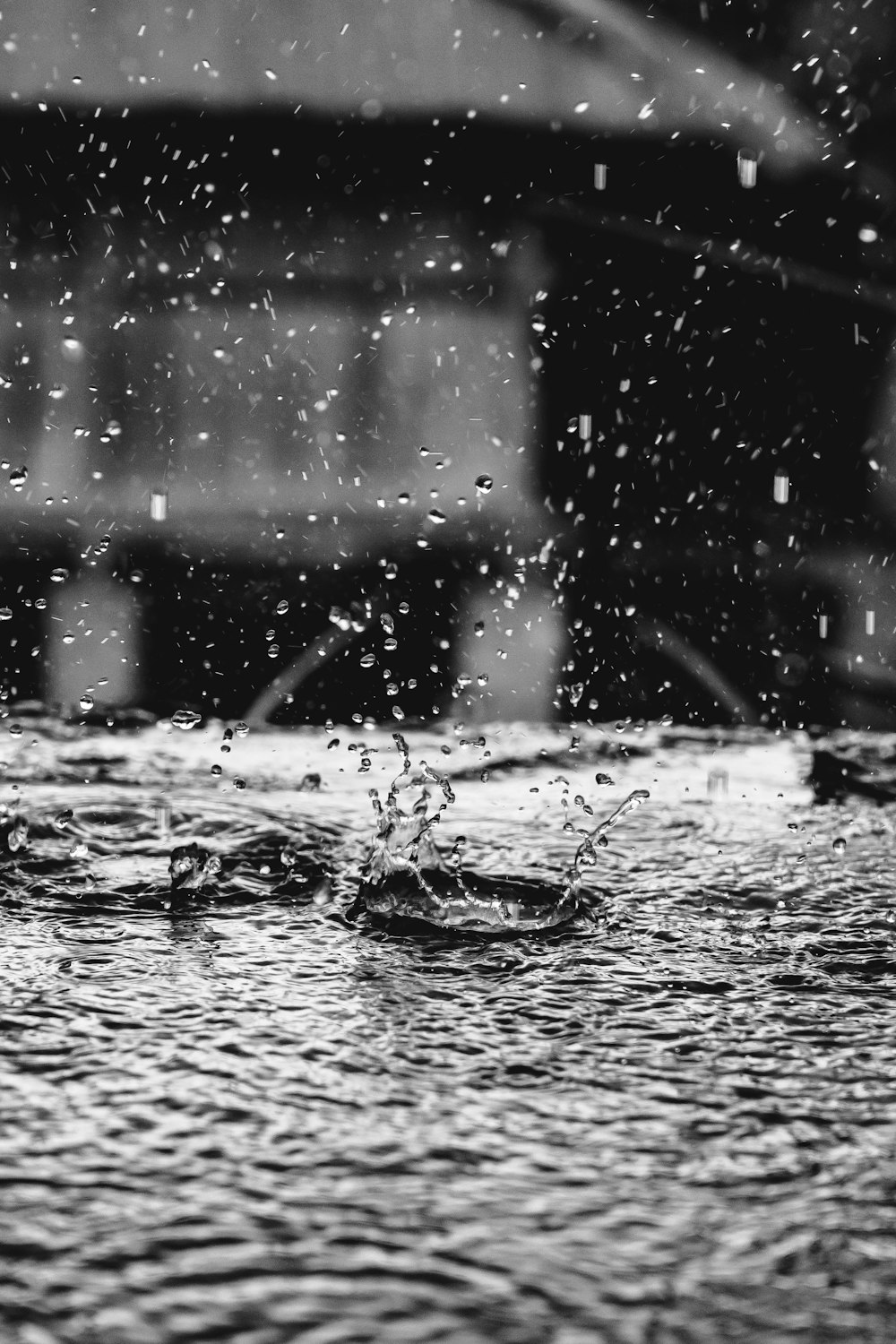 a black and white photo of a water fountain