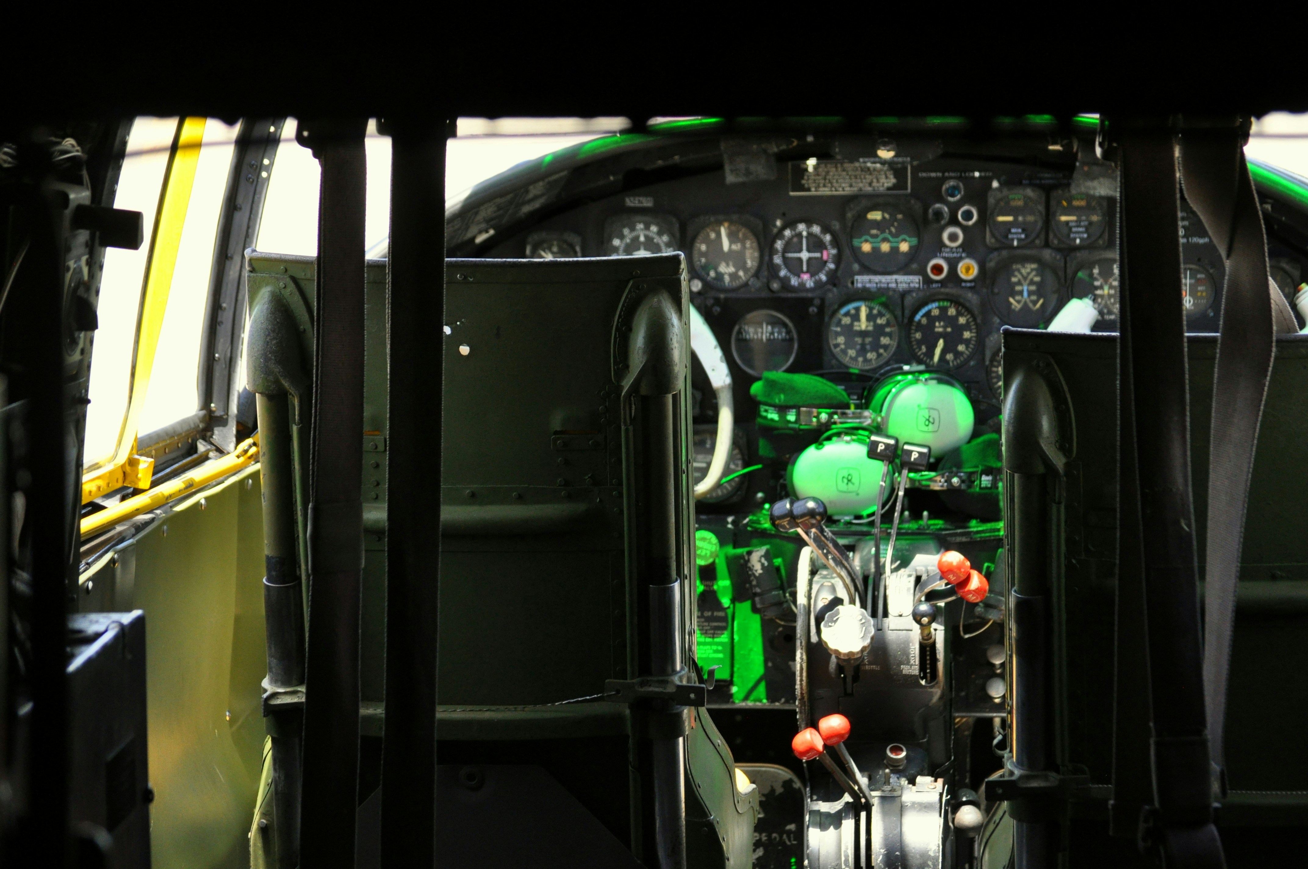 the cockpit of an airplane with a green light on, SPECIFICATIONS (B-25J)</p><p>Crew: 6 (Pilot, Co-Pilot, Bombardier/Navigator, Flight Engineer, Radio Operator and Tail Gunner)</p><p>Wingspan: 68 feet</p><p>Length: 53 feet</p><p>Maximum Speed: 272 miles per hour</p><p>Cruising Speed: 230 miles per hour</p><p>Maximum Range: 1,350 miles</p><p>Engines: Two Wright R-2600-92s (1,700 hp each)</p><p>Maximum Bomb Load: 3,200 pounds</p><p>Armament: Twelve to eighteen .50 caliber machine guns