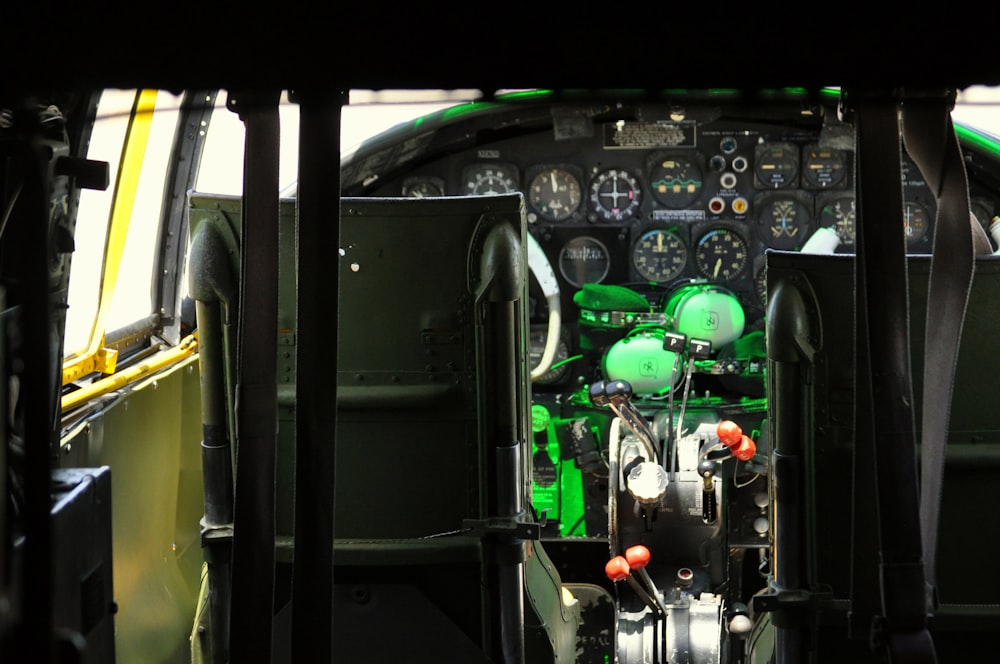 the cockpit of an airplane with a green light on
