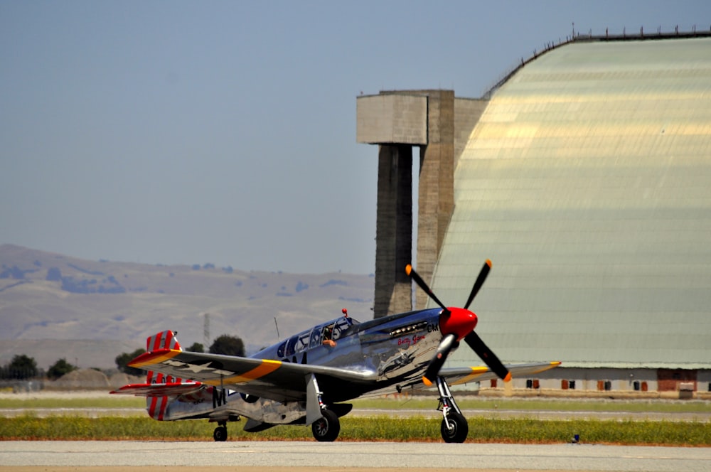 a small propeller plane sitting on top of an airport runway