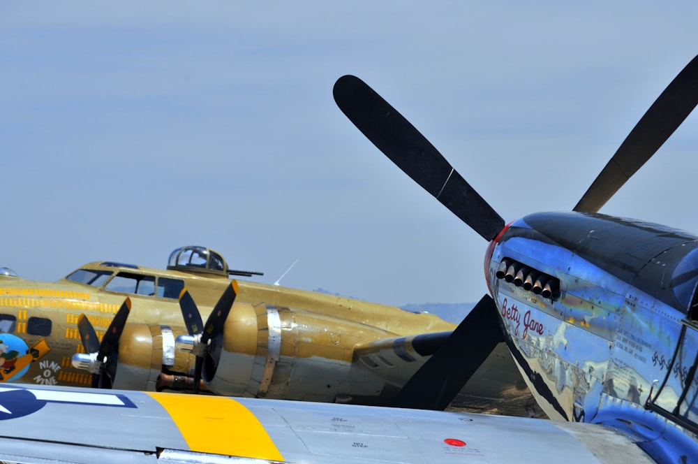 a propeller plane sitting on top of an airport tarmac