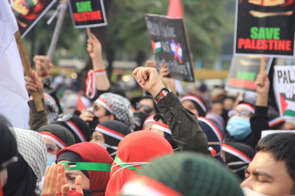 a large group of people holding up signs