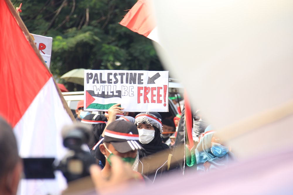 a group of people holding flags and signs