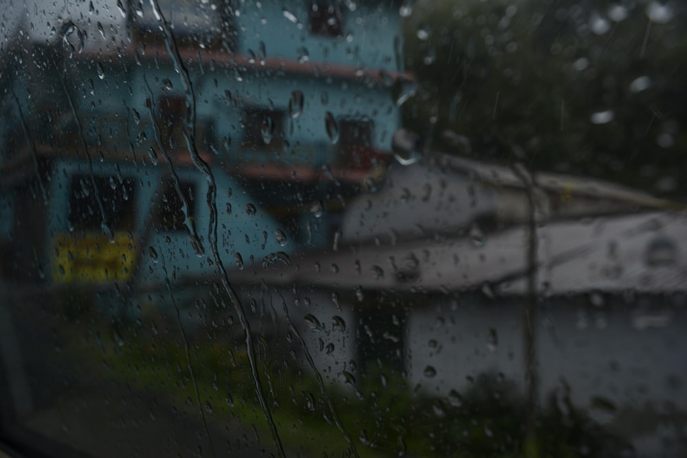 a view of a house through a rainy window