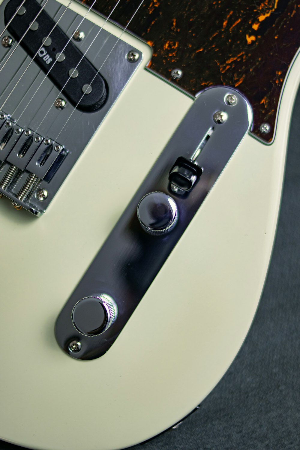 a close up of a white electric guitar