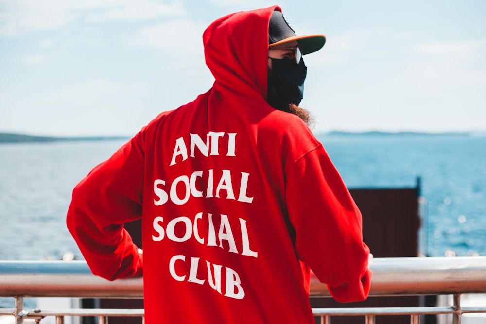 Man in red and white hoodie wearing black cap photo – Free Red Image on  Unsplash