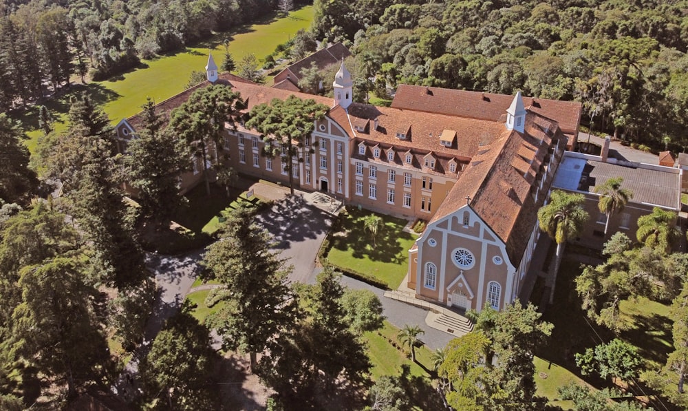 an aerial view of a large building surrounded by trees