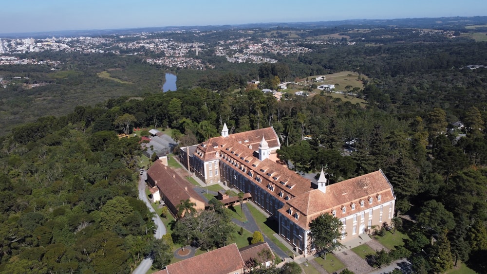 an aerial view of a large building surrounded by trees