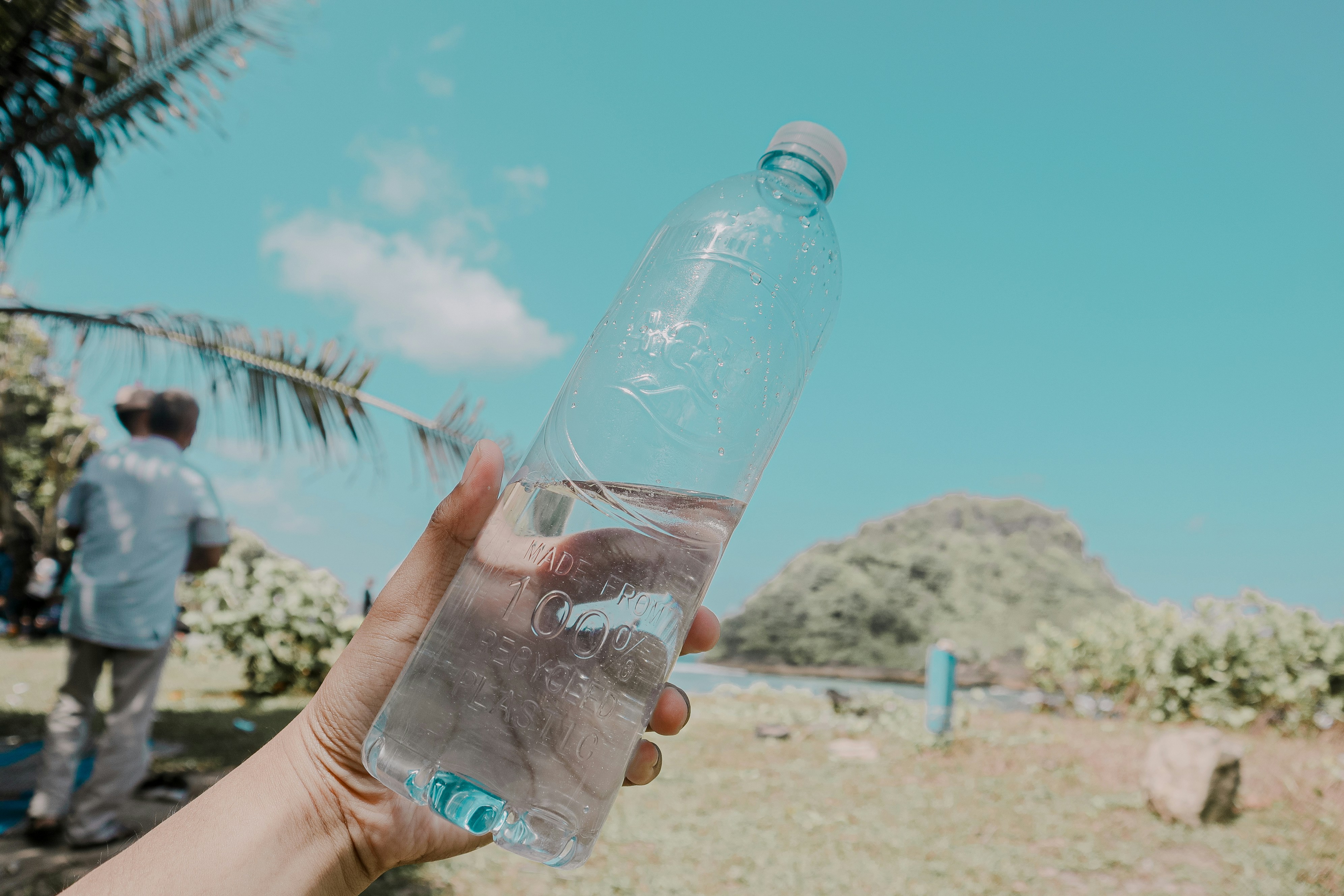 Person holding coconut bottle