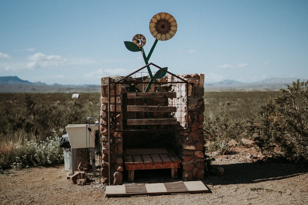 a sunflower sitting on top of a brick structure