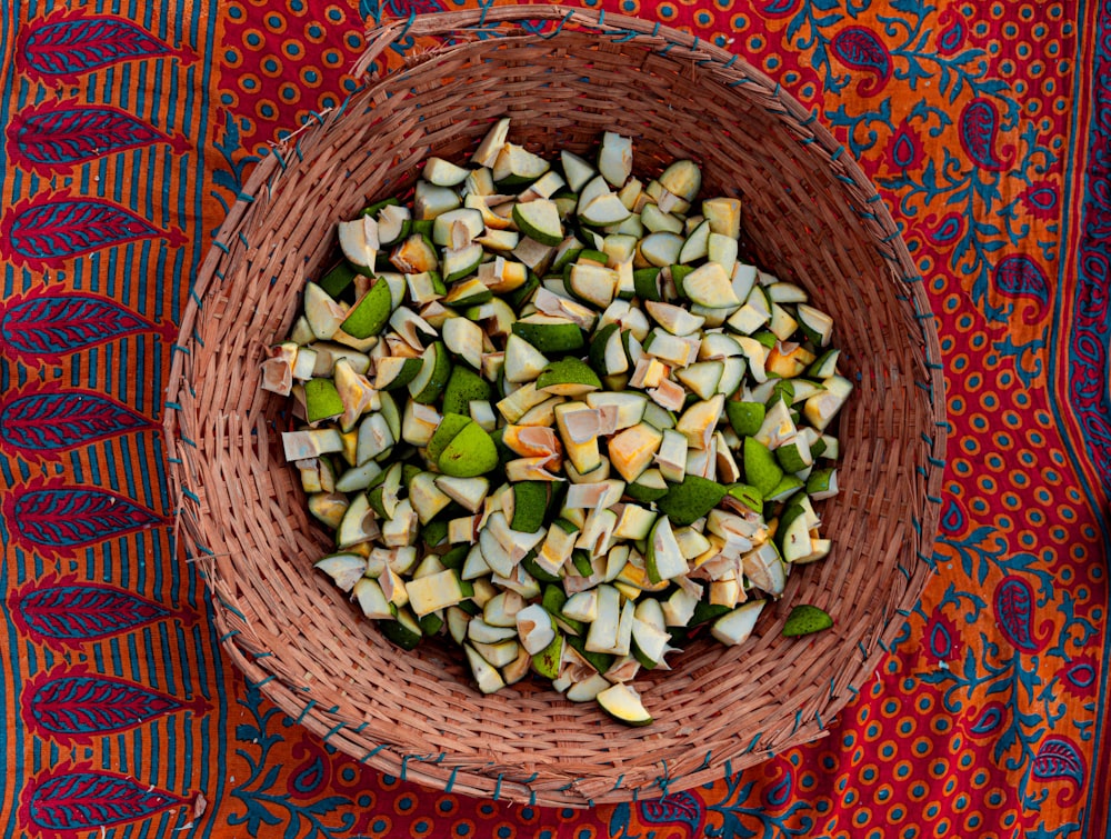 a basket filled with chopped vegetables on top of a table