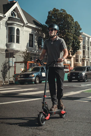 man in black t-shirt and black helmet riding bicycle on road during daytime