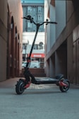 black and red bicycle with training wheels
