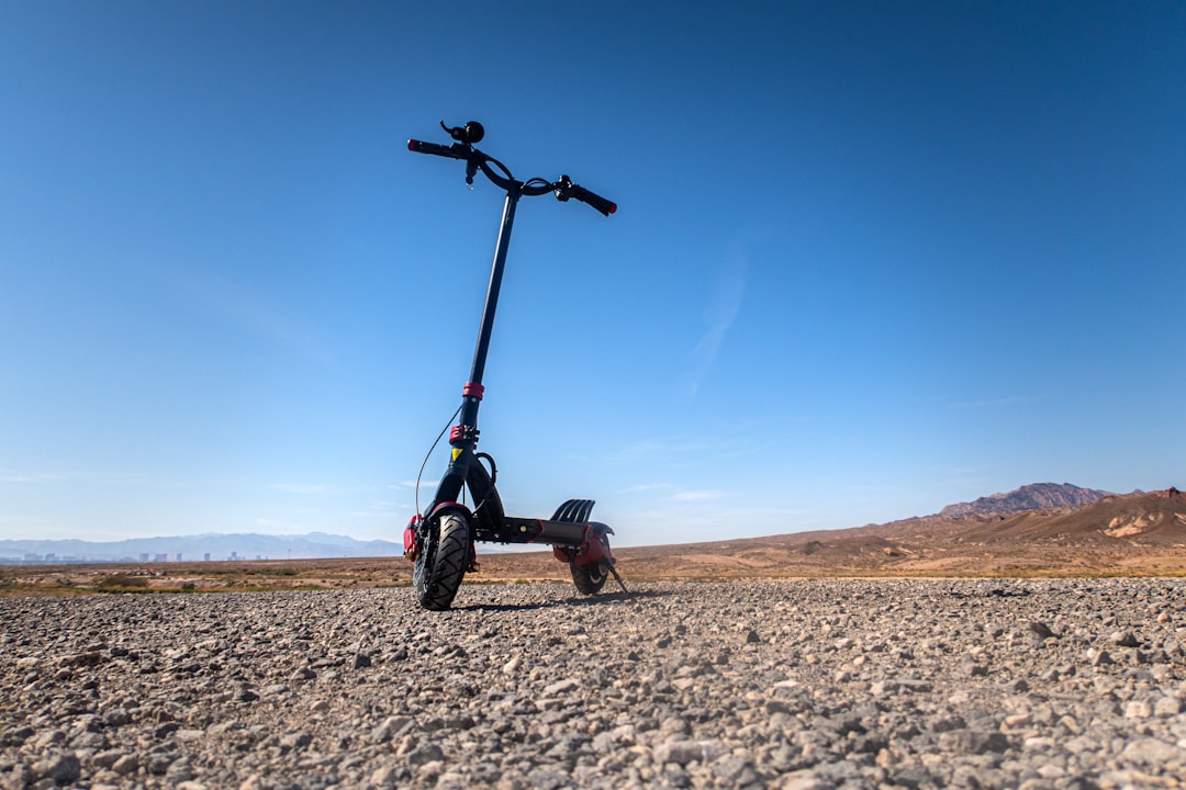 black and gray motorcycle on brown sand under blue sky during daytime