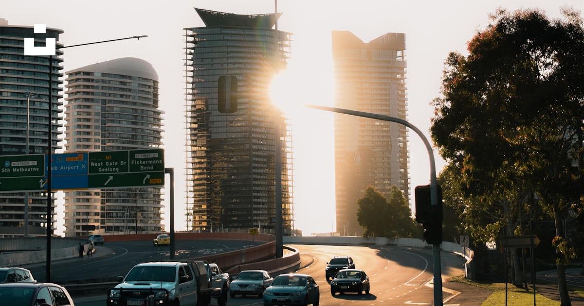 Cars parked on parking lot near high rise buildings during daytime ...