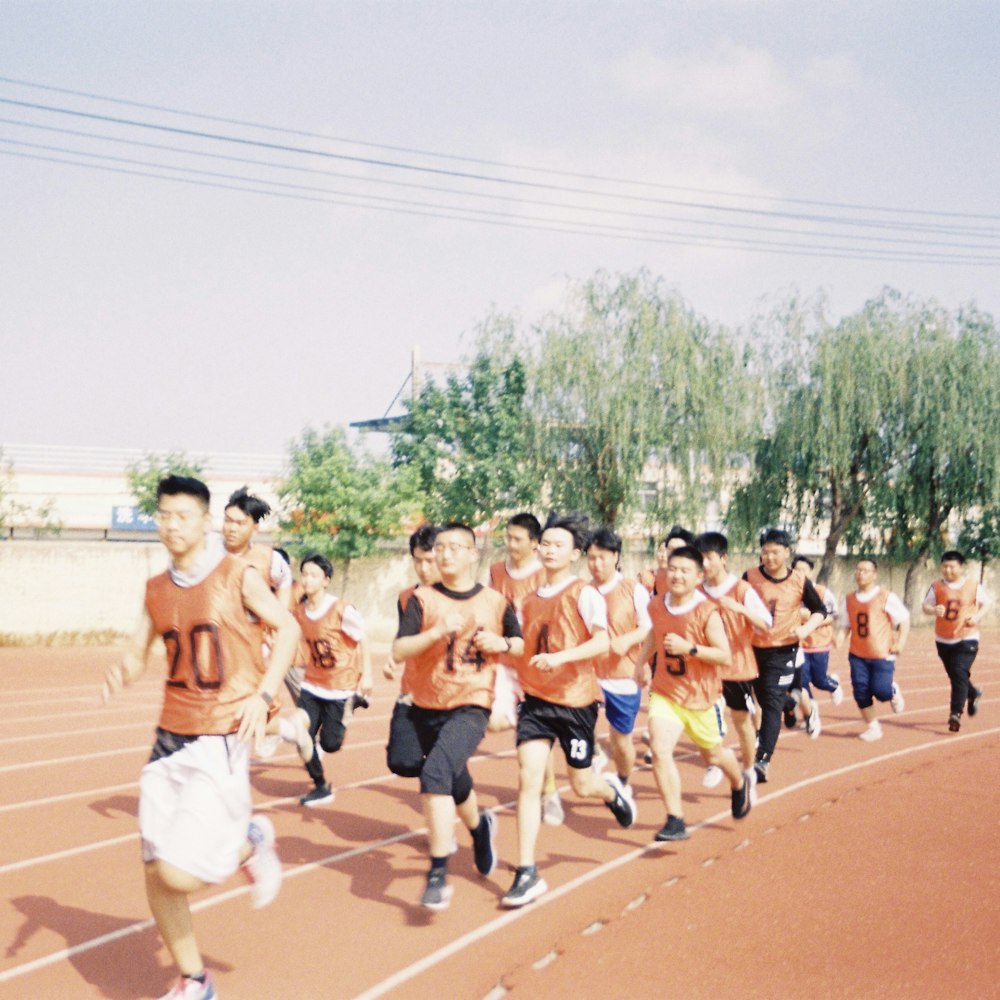 a group of young men running on a track