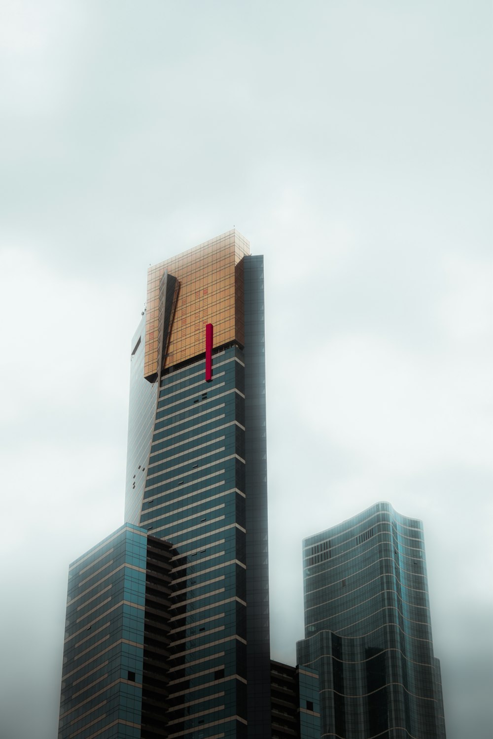 a tall building with a red object on top of it