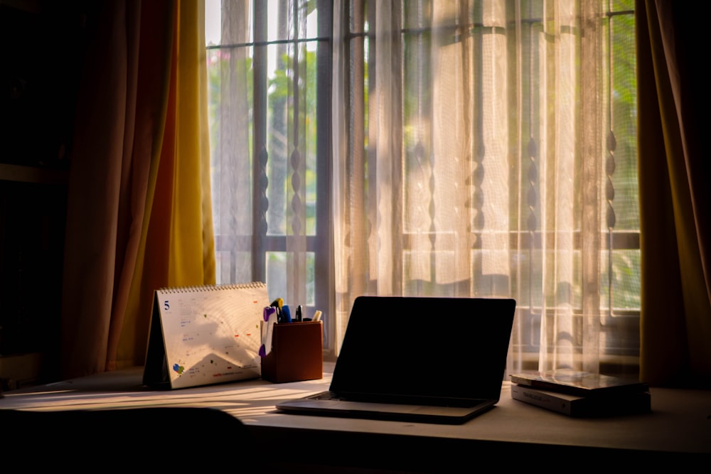 a laptop computer sitting on top of a desk