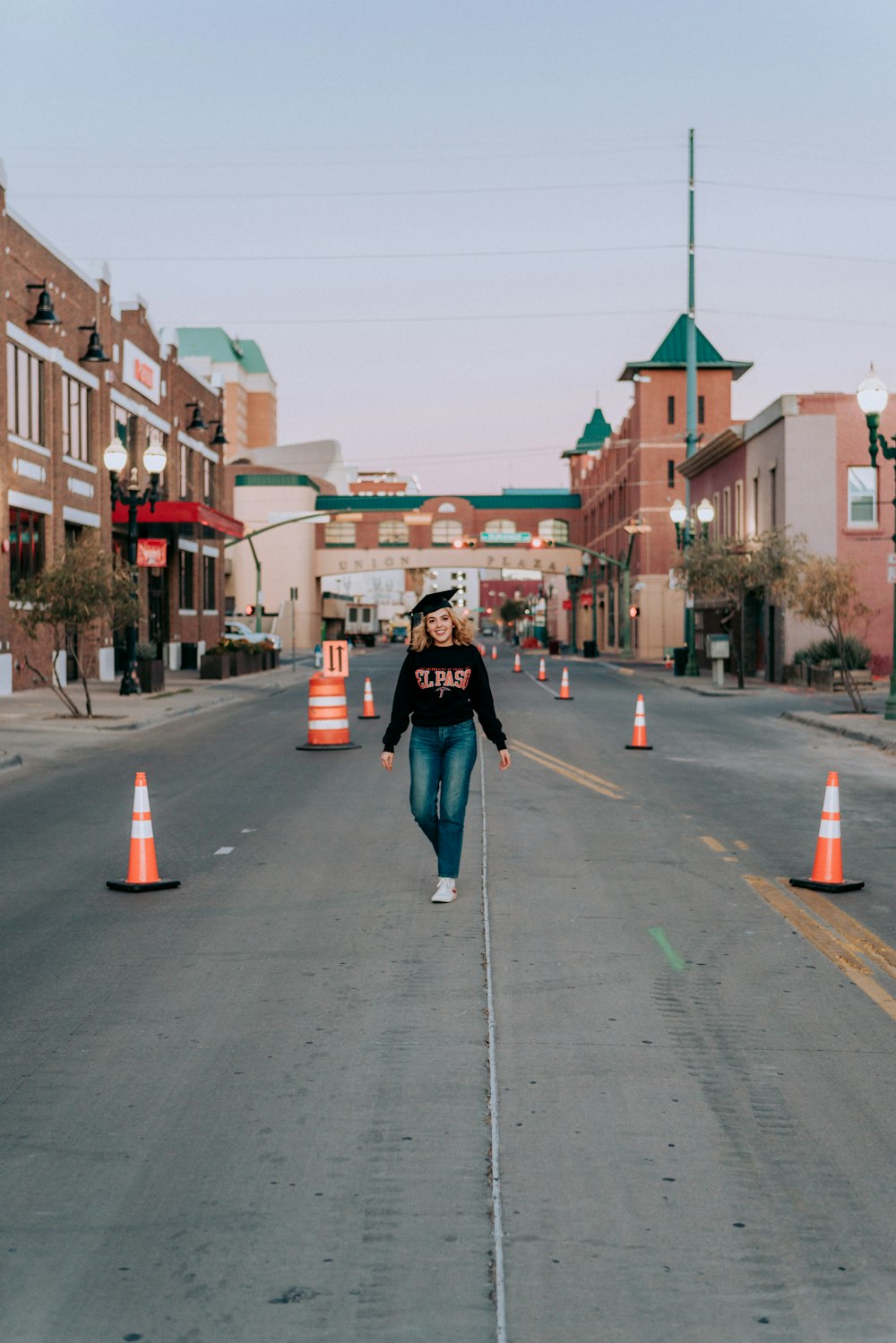 man in black jacket standing on sidewalk during daytime