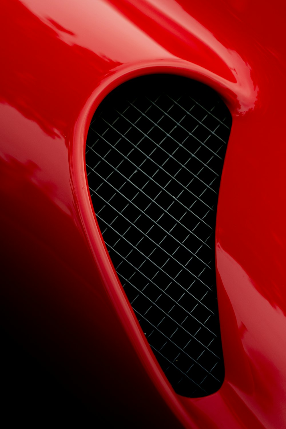 a close up of the front of a red sports car