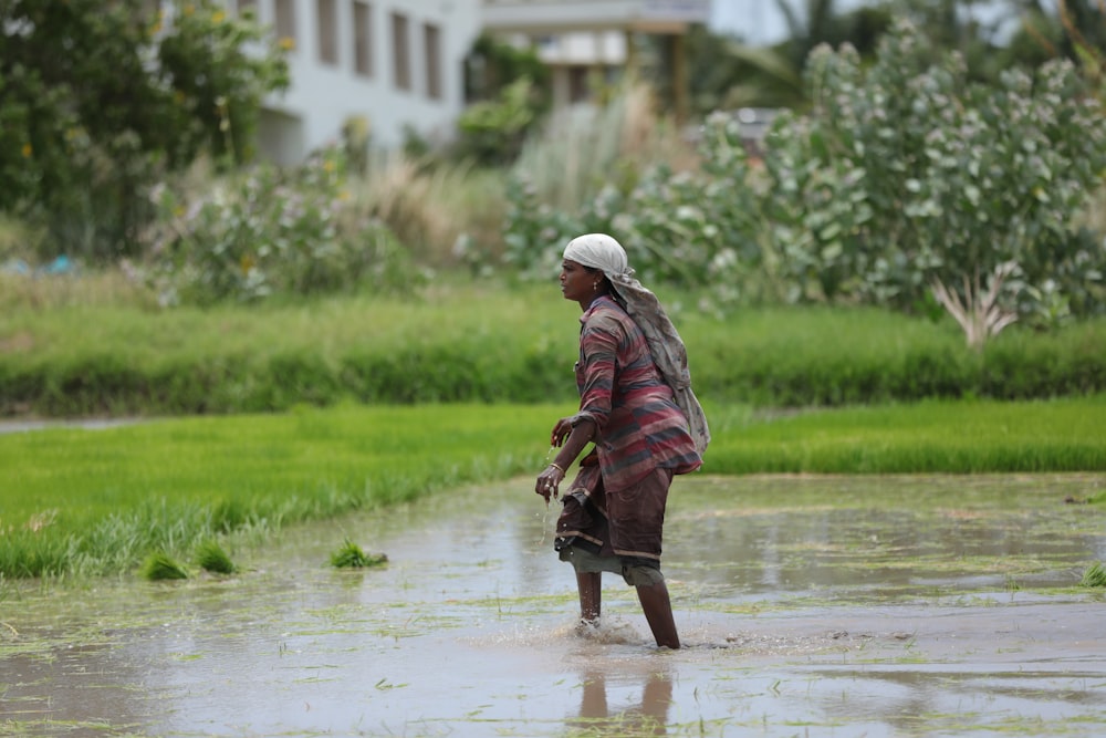 a woman walking through a flooded street