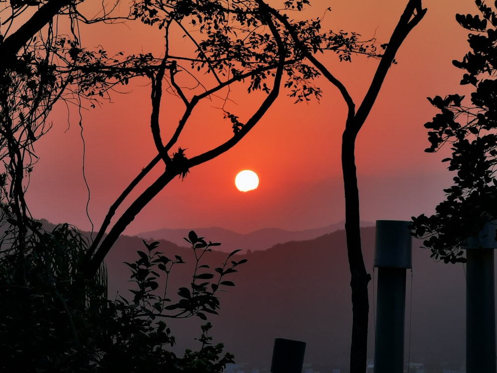 the sun is setting over a mountain range