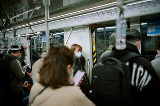 woman in beige shirt sitting on train seat