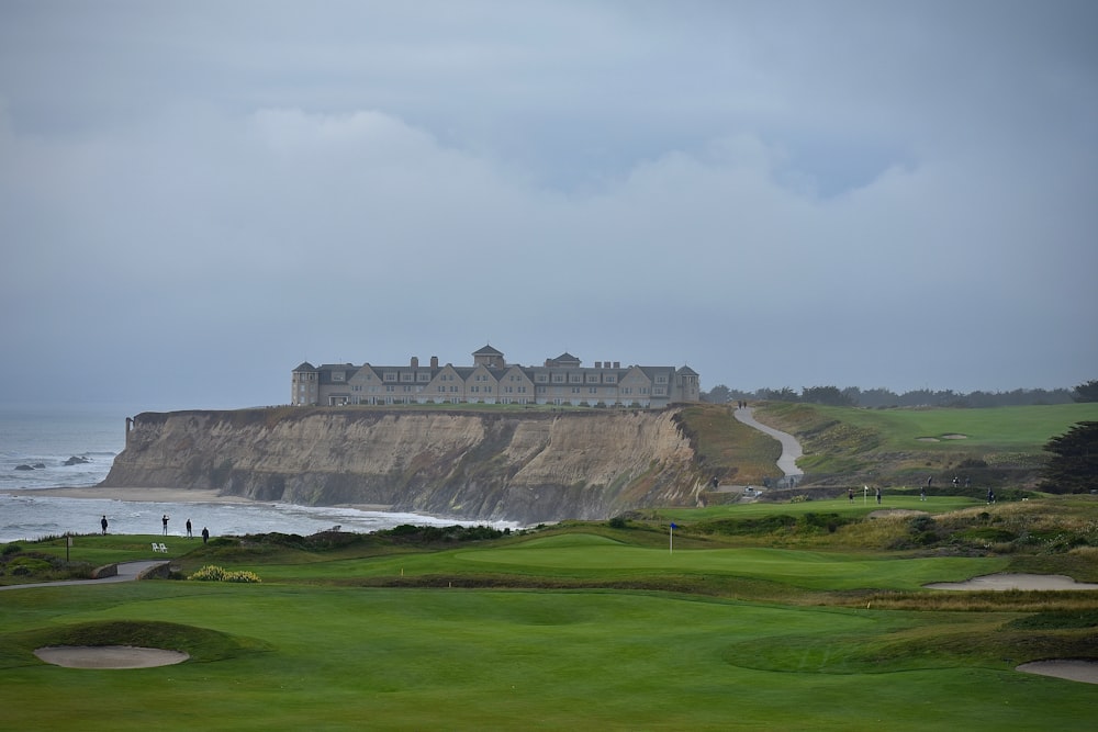 a view of a golf course with a castle in the background