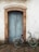 a bicycle parked in front of a blue door