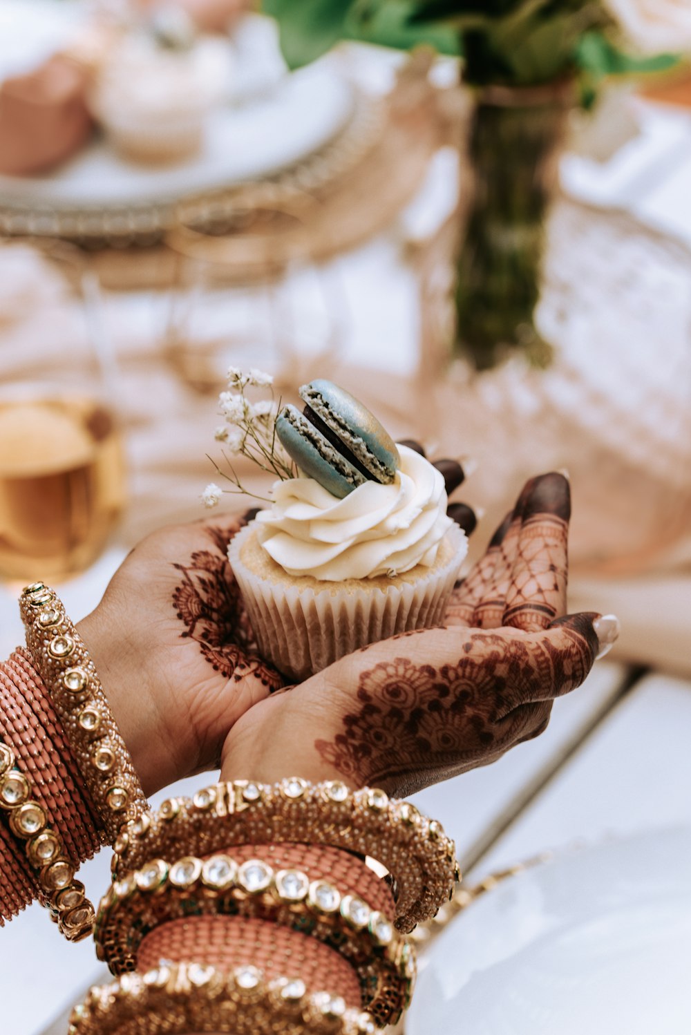 a person holding a cupcake in their hand