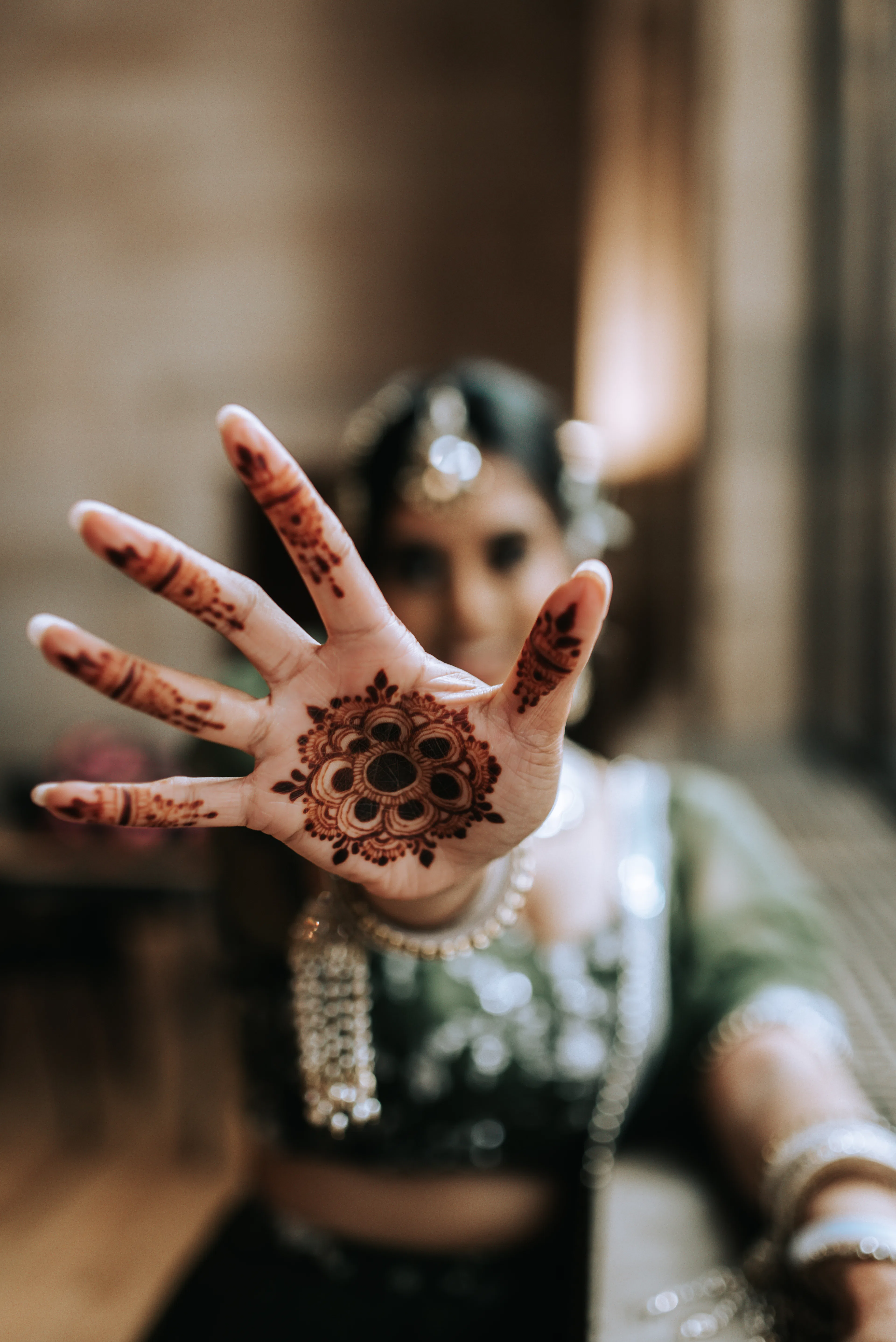 Bridal henna mandala design on an open palm
