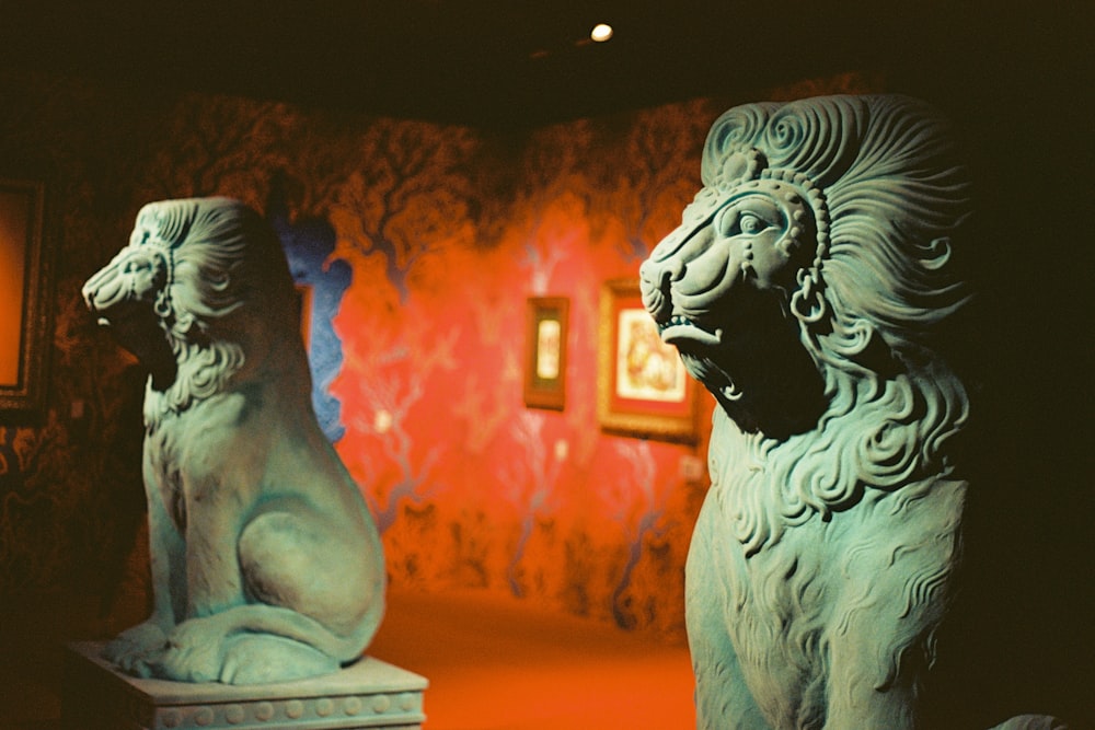 a couple of statues of lions sitting next to each other
