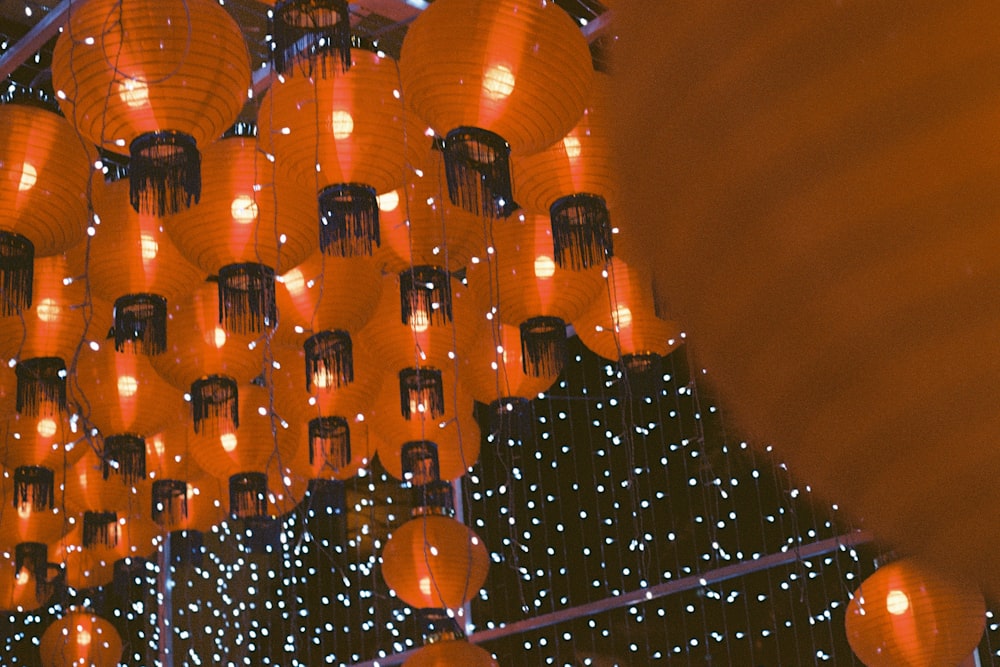 a bunch of lanterns hanging from the ceiling