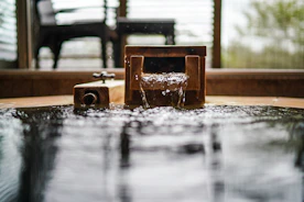 a water fountain with a wooden bench in the background