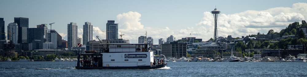 a boat traveling on the water in front of a city