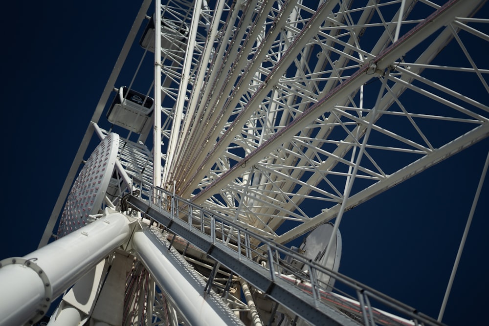 a close up of a ferris wheel against a blue sky