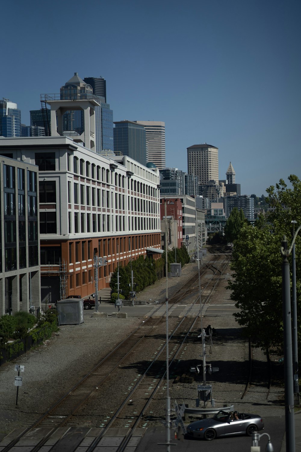 a train track running through a city with tall buildings