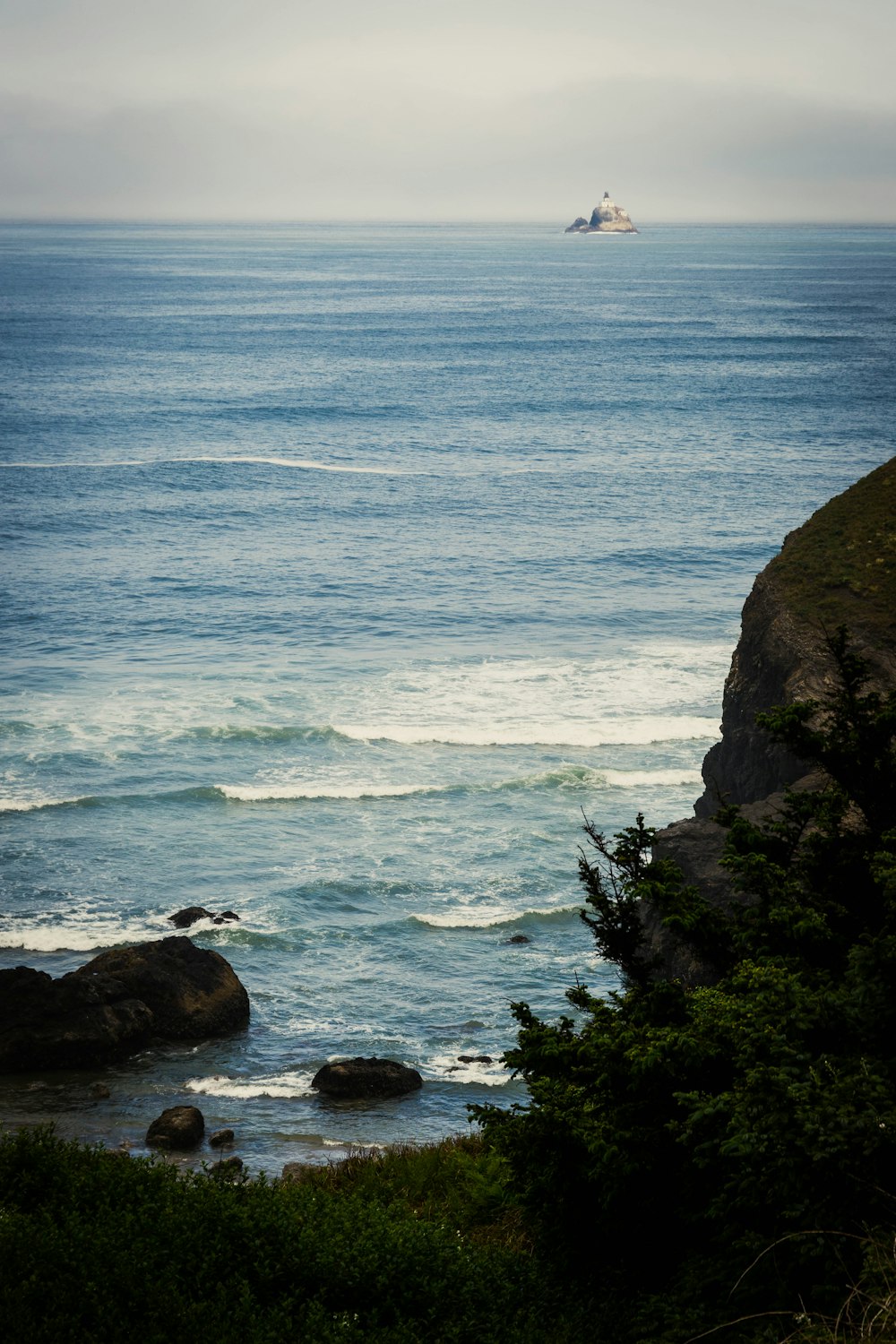 a boat is out in the ocean on a cloudy day