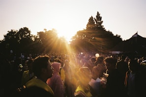 Crowd applauding at an outdoor Premutiba awards ceremony at sunset