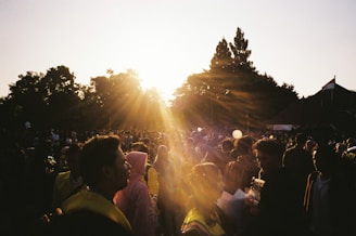 Crowd applauding at an outdoor Premutiba awards ceremony at sunset