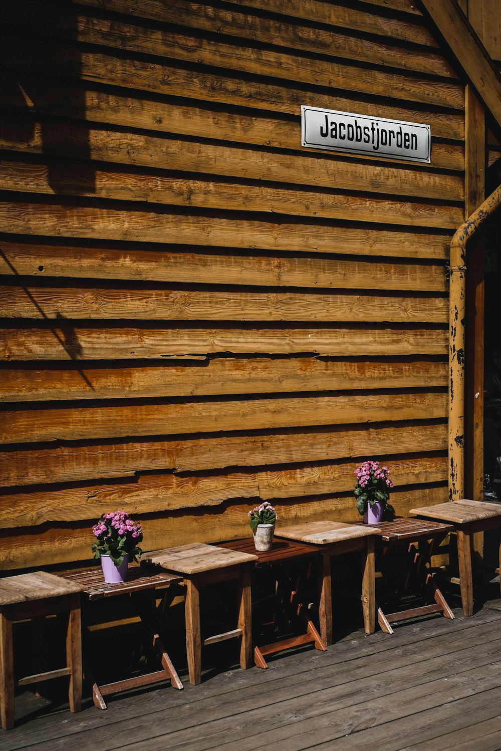 a group of wooden benches sitting on top of a wooden floor