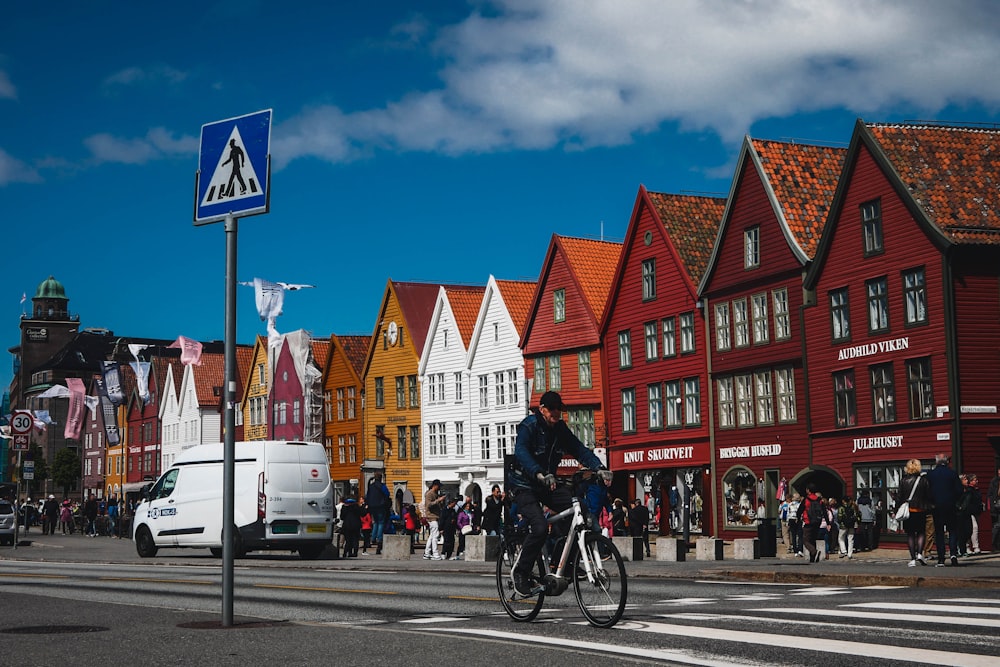 man in black jacket riding bicycle on road during daytime