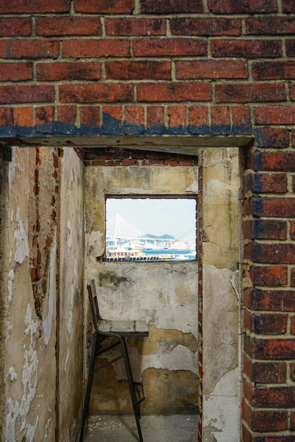 a window in a brick wall with a ladder