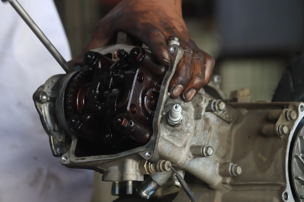 a close up of a person working on an engine