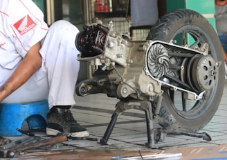 a man is working on a motorcycle engine