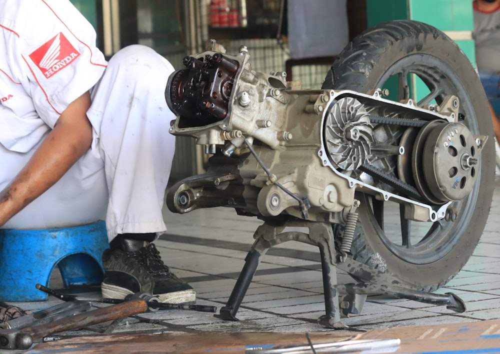 a man is working on a motorcycle engine
