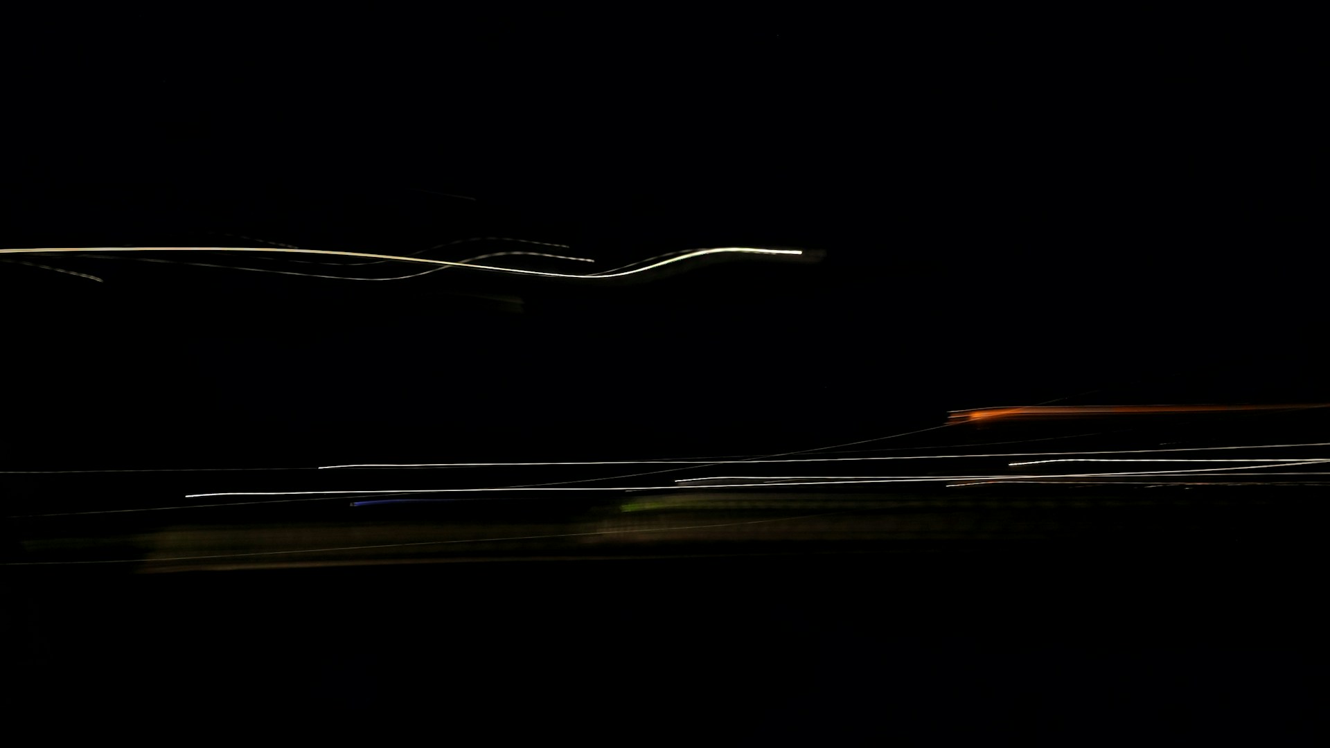 a blurry photo of a car driving in the dark