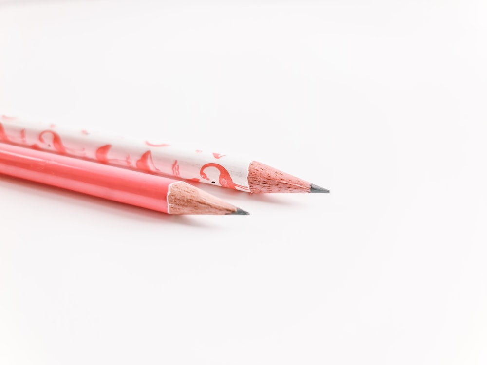 two pencils with the word love written on them